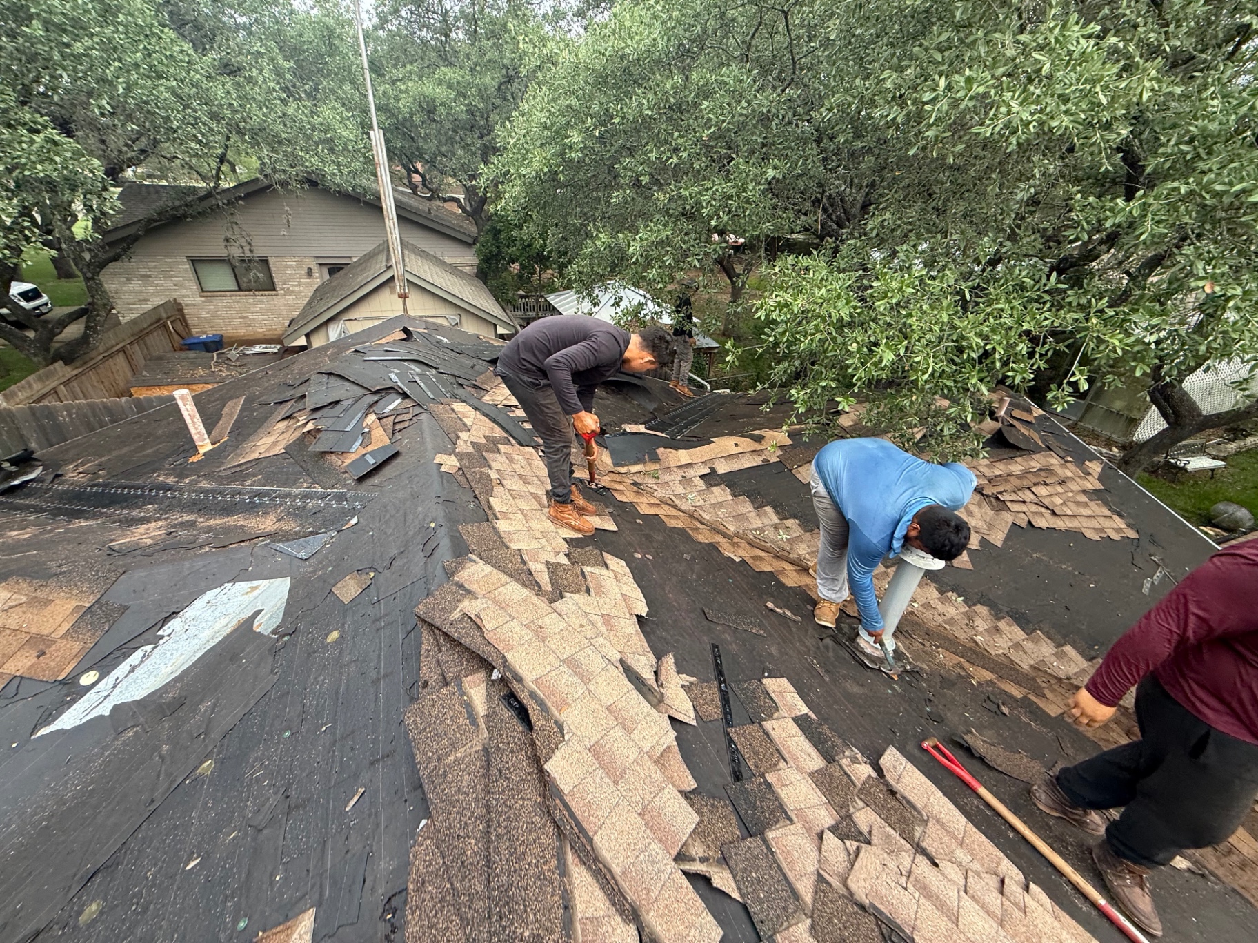 Crew tearing off the existing roof in Hollywood Park before installing new GAF Timberline HDZ shingles
