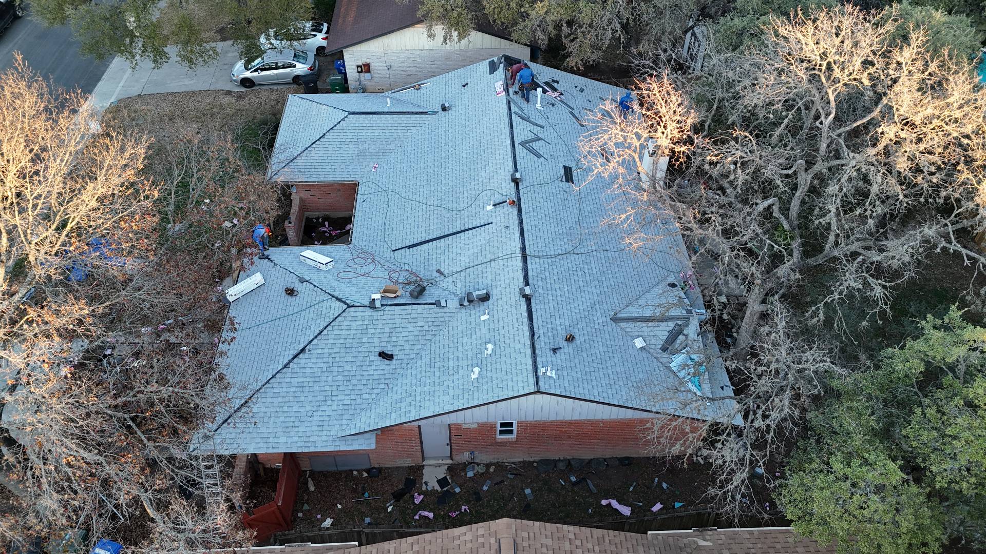 Completed Owens Corning white shingle roof at golden hour