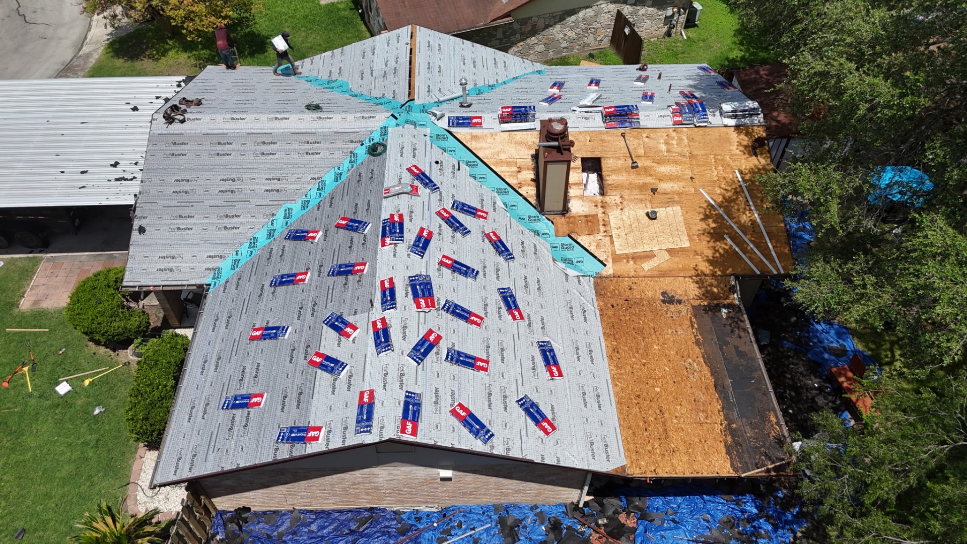 GAF FeltBuster synthetic underlayment and StormGuard installed with GAF Timberline HDZ shingles staged on the roof