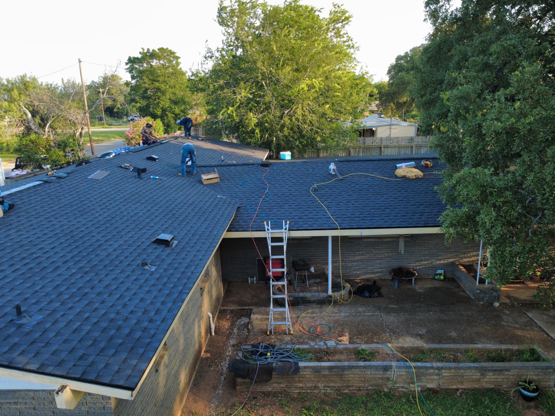 Crew installing and finishing GAF Timberline HDZ Class 3 shingles on Pearsall home