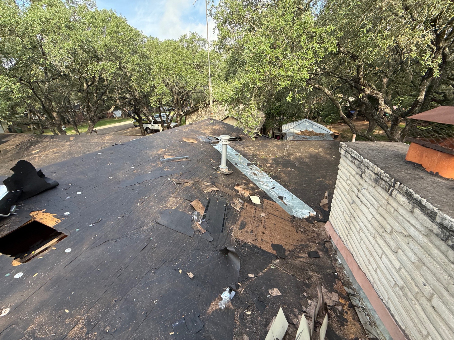 Hollywood Park roof with exposed underlayment and open decking area during tear-off