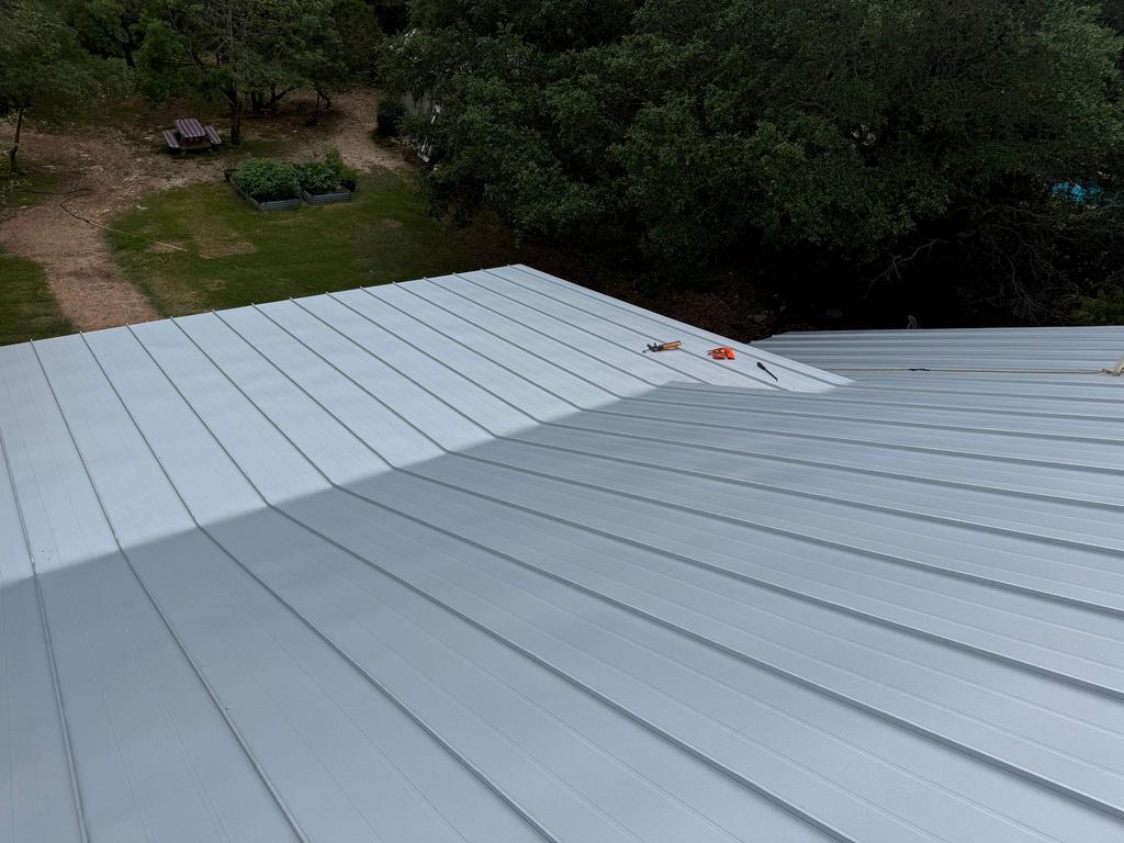 Completed standing seam roof slope overlooking the Hill Country