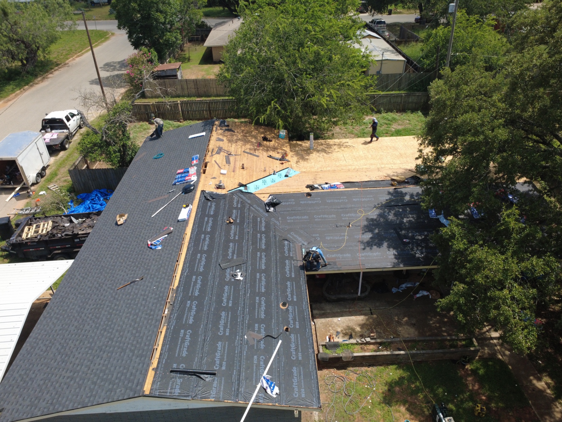 Synthetic underlayment and staged material installation in progress on Pearsall home