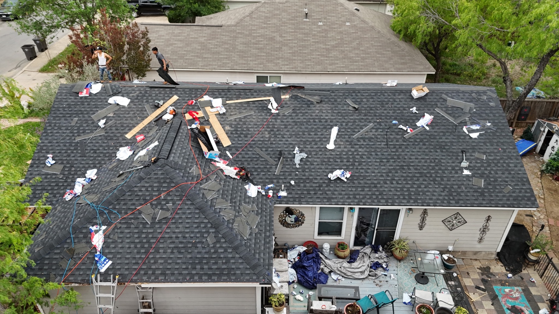 Rear patio view of West Side San Antonio roof replacement showing ridge detail during install