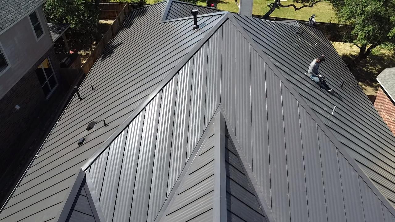 Ridge-level view of completed standing seam metal roof in San Antonio