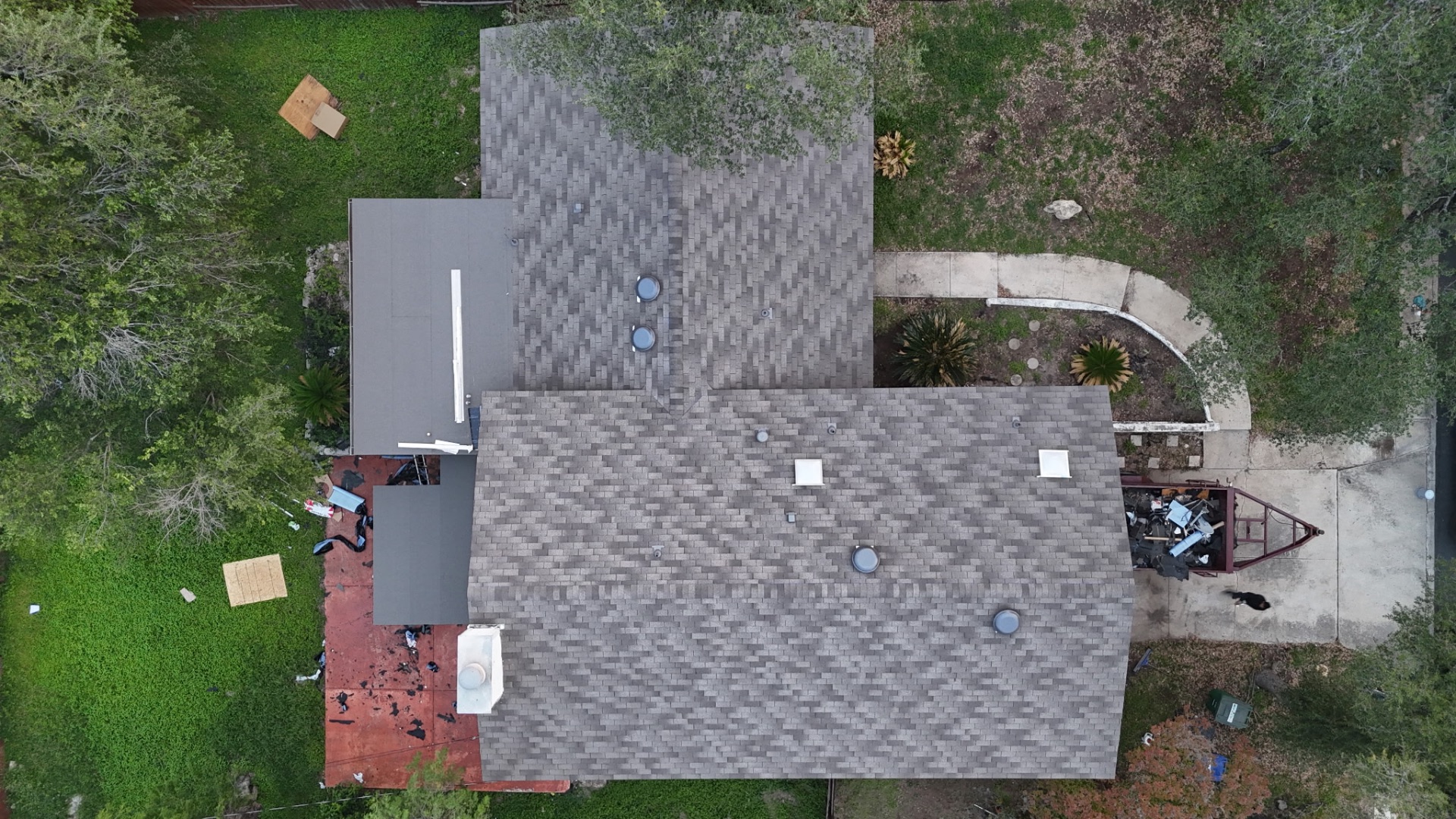 Top-down drone view of completed asphalt shingle roof on San Antonio home