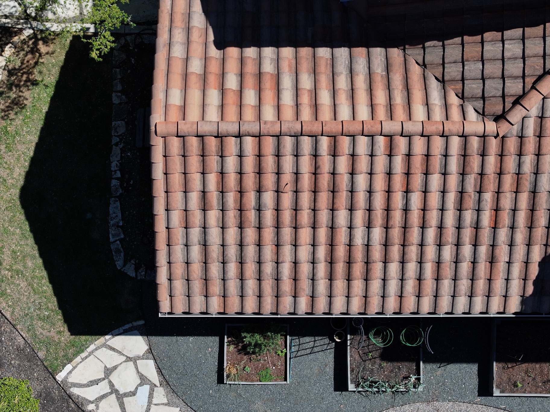 High drone view of lower roof section after targeted tile repair in Boerne