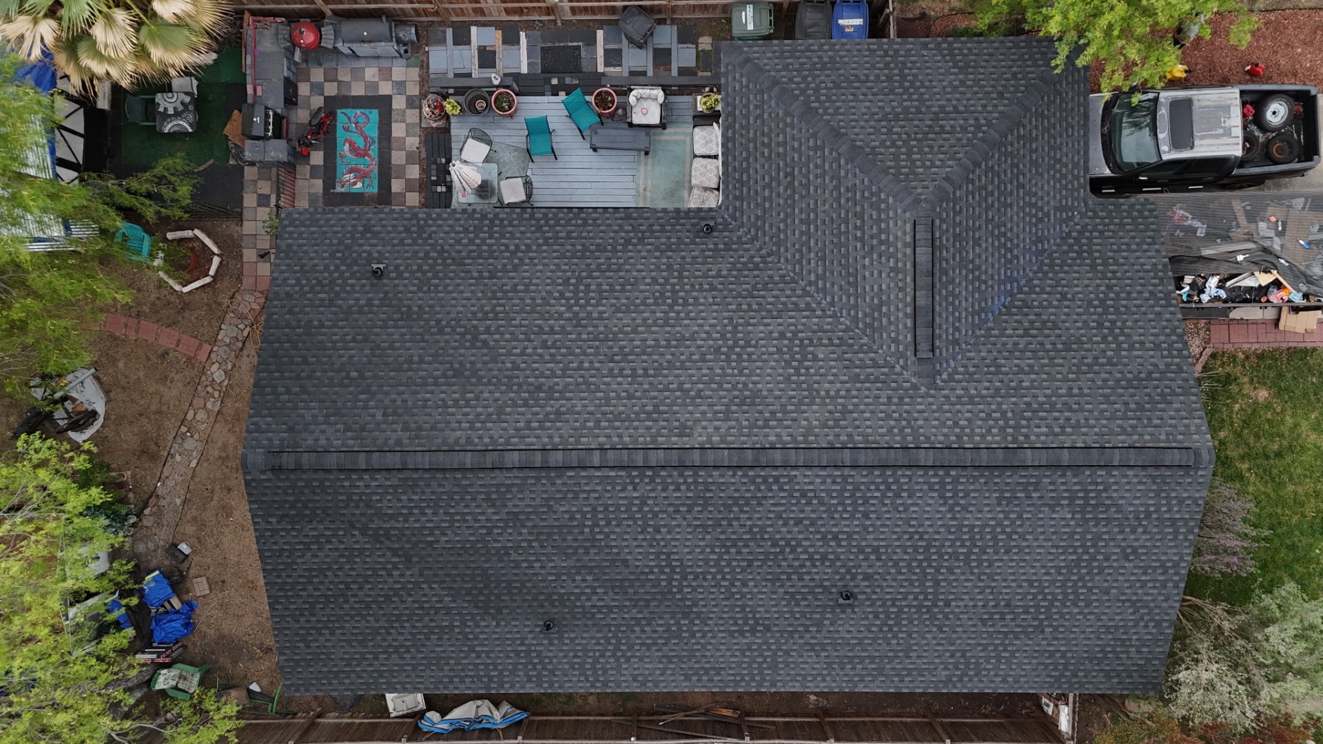 Completed overhead drone photo of finished charcoal shingle roof on West Side San Antonio home