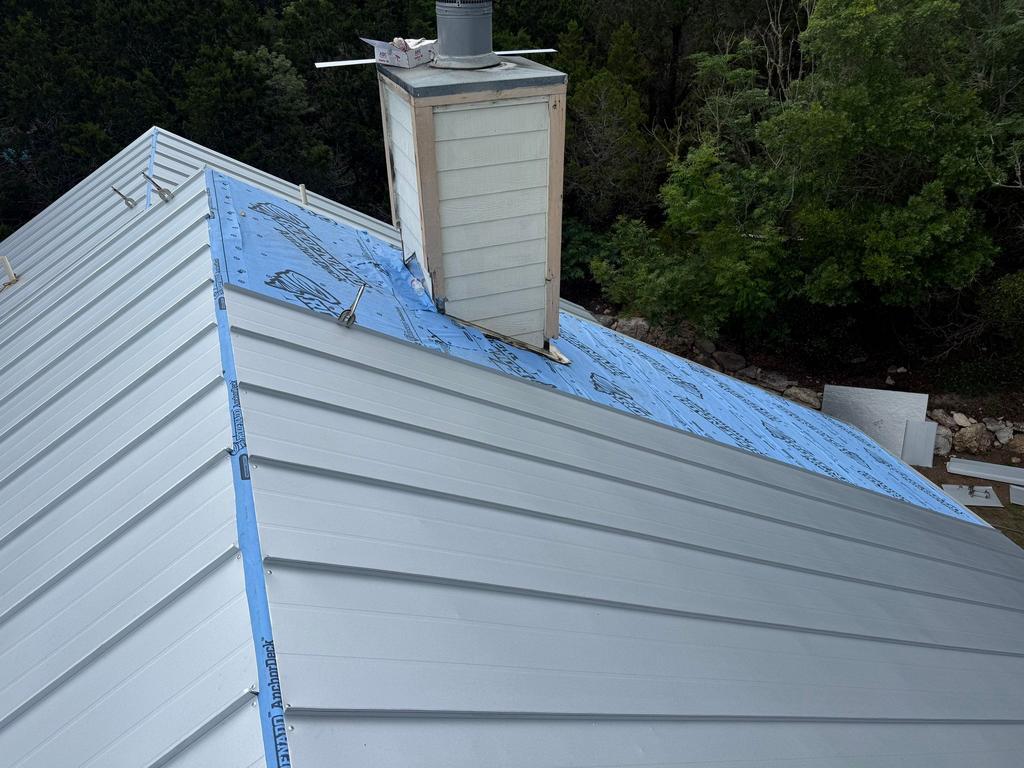 Detail of standing seam panels meeting chimney flashing