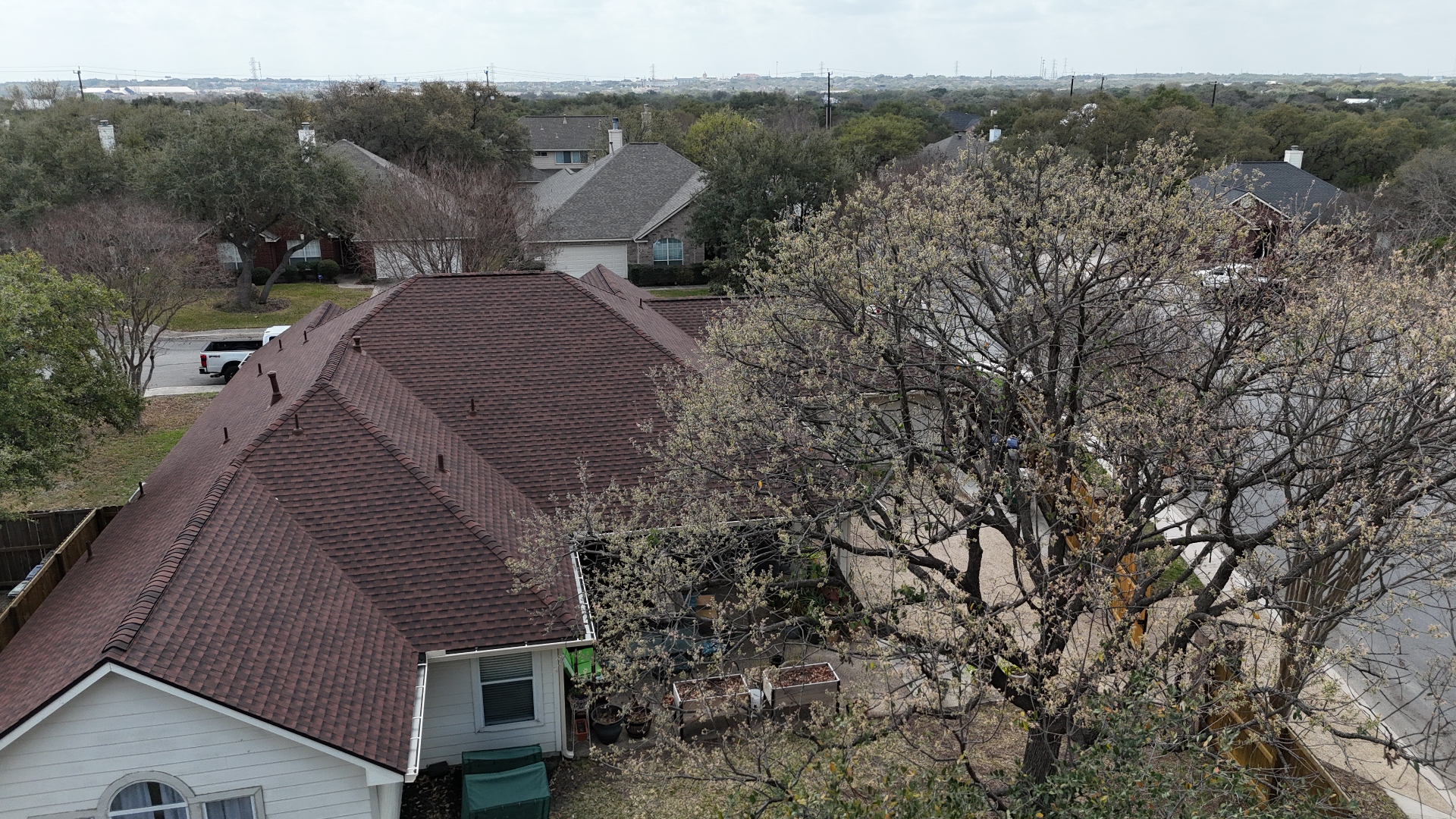 Aerial detail of finished Helotes shingle roof with rich multi-tonal blend