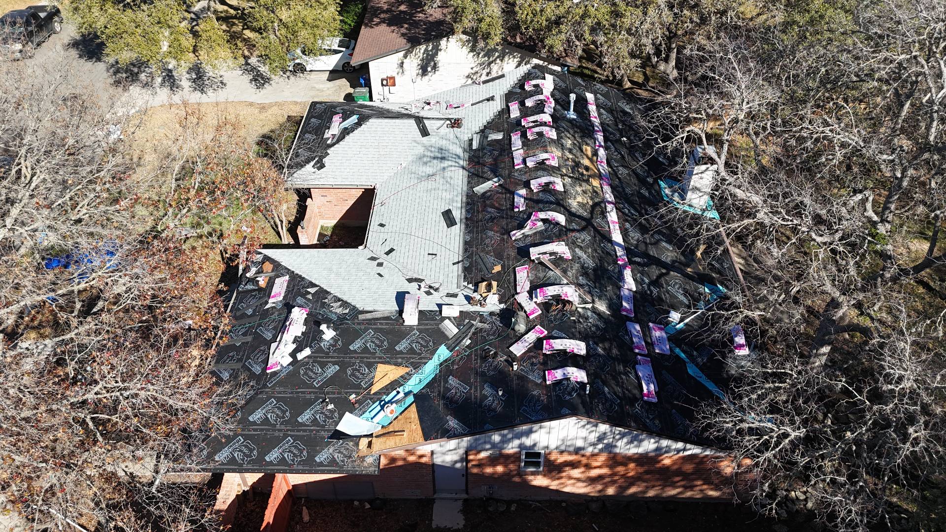 Aerial view of Owens Corning shingle install progressing across multiple slopes