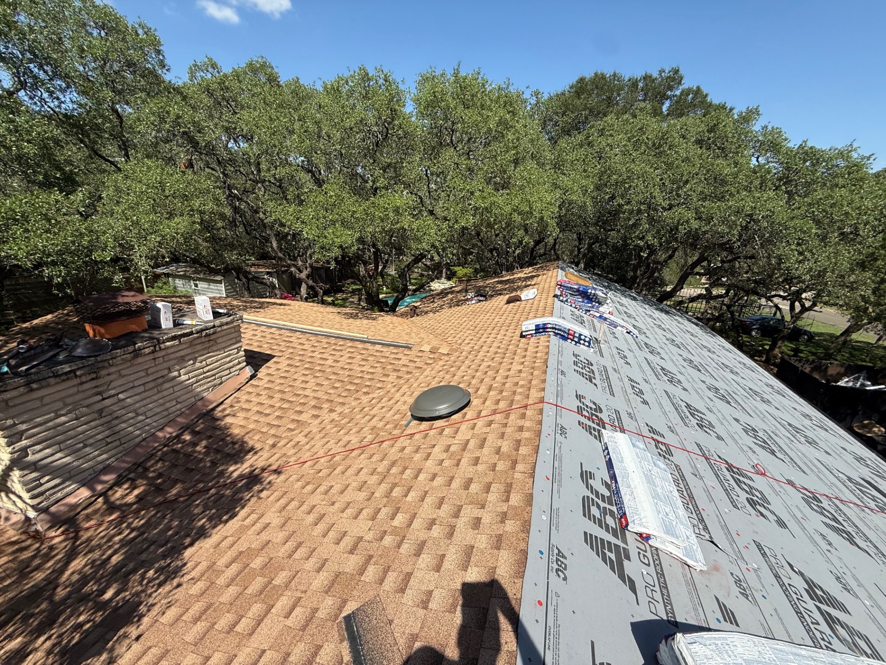 Crew installing underlayment and preparing the Hollywood Park roof for GAF Timberline HDZ shingles