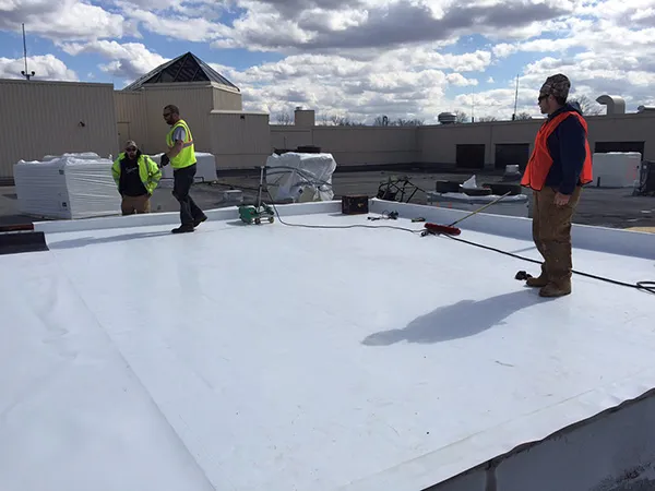 Aerial view of a commercial flat roof TPO installation in Texas